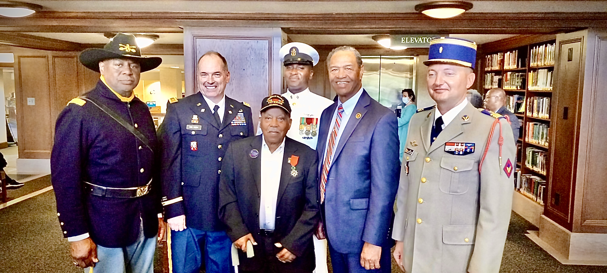 Veterans and honorees, including a WWII veteran awarded the French Legion of Honor, gathered together
