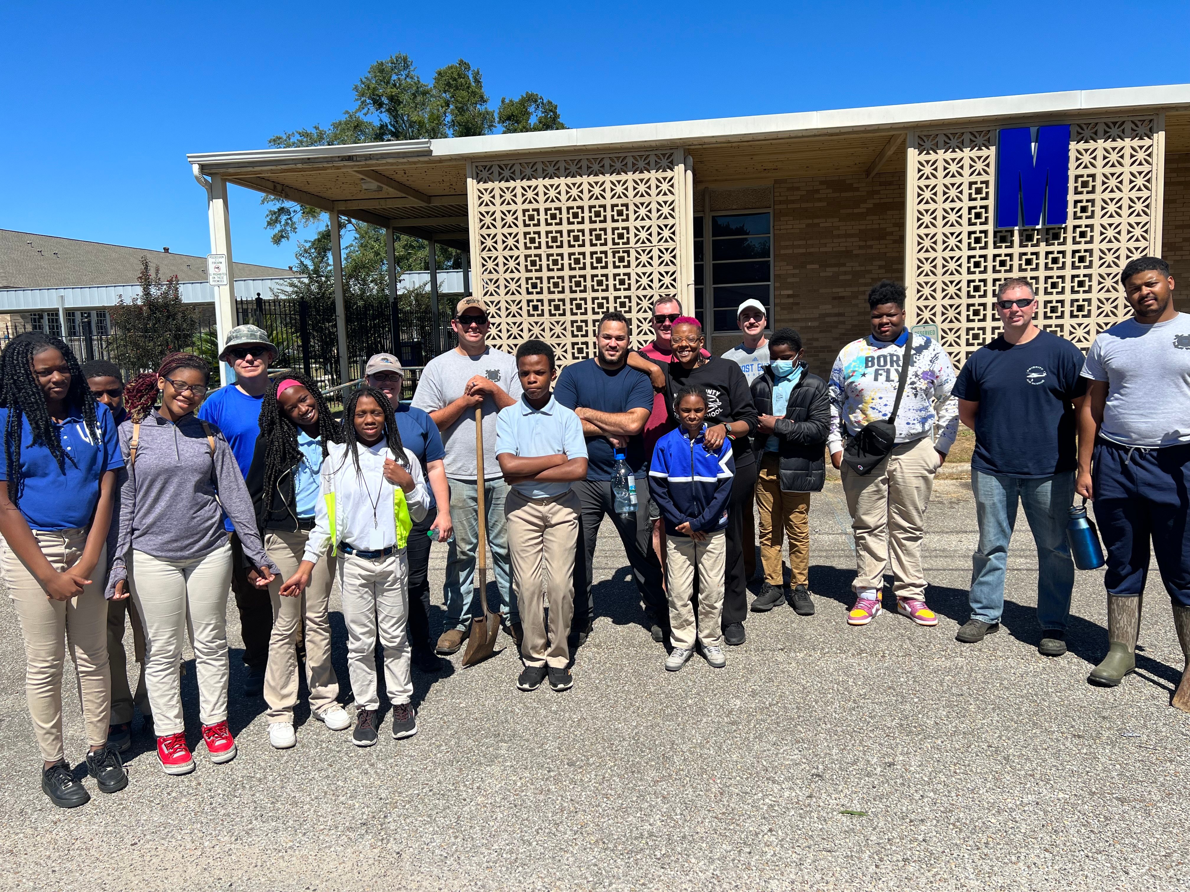 Students and volunteers gathered outside Mobile County Training School for a composting transition project