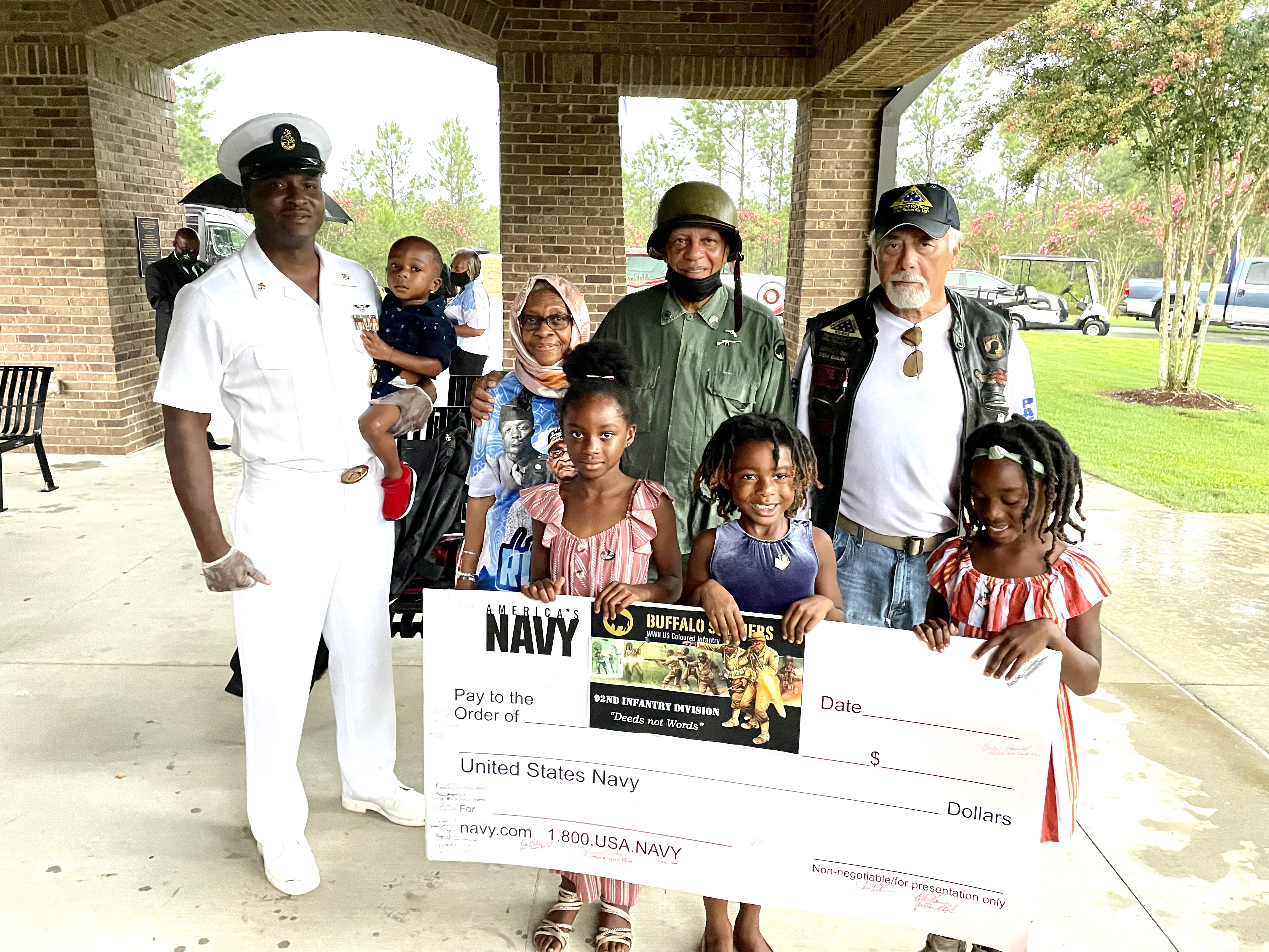 Navy service members, veterans, and children at a Buffalo Soldiers 92nd Infantry Division recognition ceremony